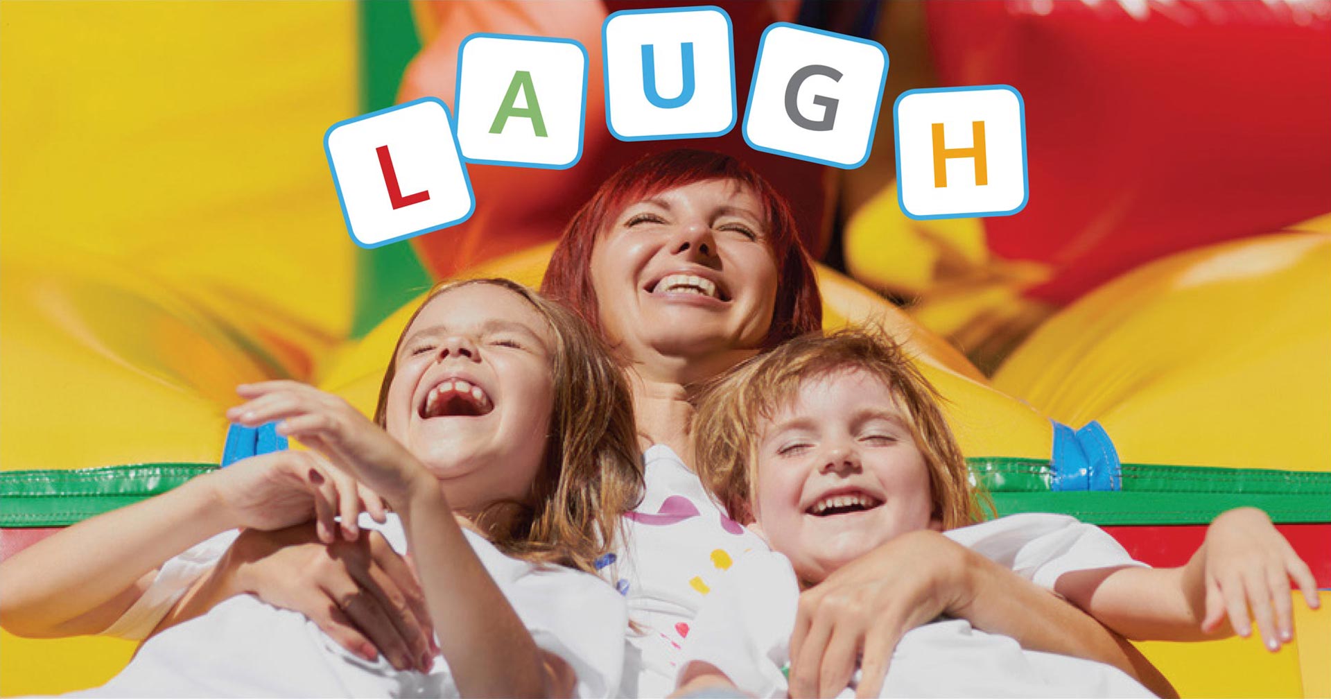 laughing mom and children on inflatable bouncy castle